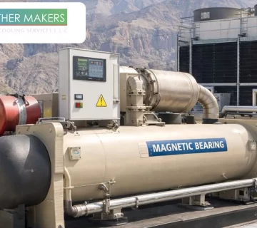 A large scale industrial magnetic bearing chiller unit installed at an outdoor facility with a control panel and "Magnetic Bearing" signage, showcasing energy efficient cooling technology by Weather Makers 