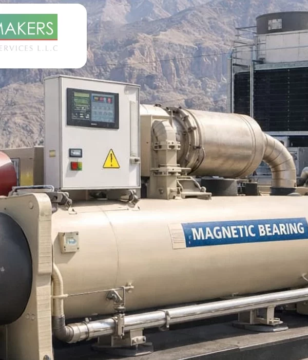 A large scale industrial magnetic bearing chiller unit installed at an outdoor facility with a control panel and "Magnetic Bearing" signage, showcasing energy efficient cooling technology by Weather Makers 