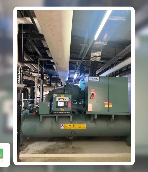 Common Mistakes in Chiller System Design and How to Avoid Them Chiller system design featuring a YORK centrifugal chiller installed in a mechanical room with overhead HVAC piping and ductwork